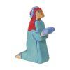 Holztiger nativity figure, kneeling Balthasar king in blue robe and with gift in hand.